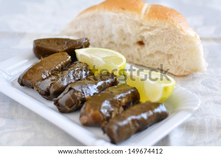 Dolmades with lemon wedges and pita bread