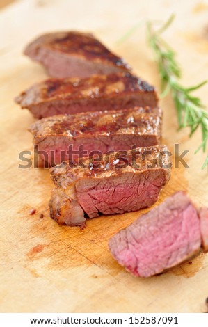 Grilled steak on wooden chopping board