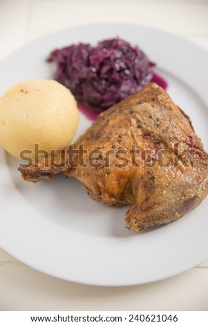 Roast duck legs with potato dumplings and red cabbage