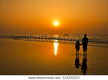Rise like the sun and enlighten all -Father to Daughter watching sunrise on a beach