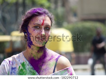 BANGALORE, INDIA - MARCH 8: An unidentified young lady with face painted in colors celebrates the festival of Holi at Bangalore, India on March 8, 2012