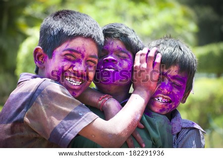 BANGALORE, INDIA - MARCH 8: A group of unidentified young boys with face painted in colors celebrates the festival of Holi at Bangalore, India on March 8, 2012
