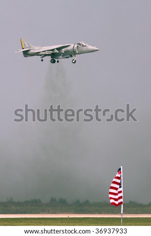 CLEVELAND, OHIO - SEPT. 6: A Harrier fighter Jet hovering over a runway with an American flag at the bottom of the picture at the Cleveland National Airshow on Sept. 6, 2009 in Cleveland, Ohio.