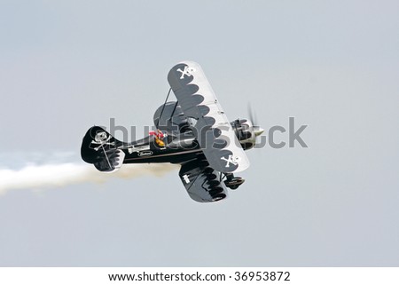 CLEVELAND, OHIO - SEPT. 6: Black stunt plane with skull and cross bones flies at the Cleveland National Airshow on Sept. 6, 2009 in Cleveland, Ohio.