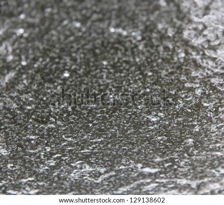 An ice covered windshield looking from the inside out