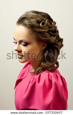 model in pink dress with makeup and curly hair