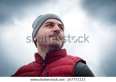 handsome sporty man on the storm sky background