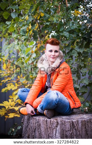 amazing punk model with orange mohawk outdoors