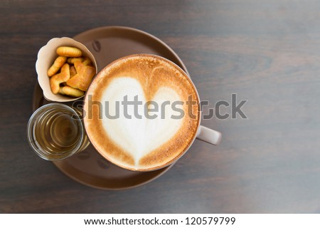 a cup of coffee heart on table