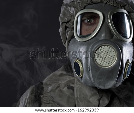 The man in a gas mask in smoke