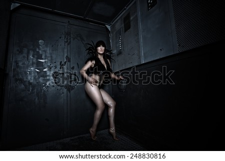 Sexy woman in a mysterious styling in the old elevator