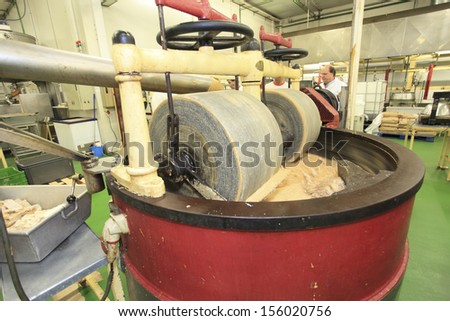 JIJONA, ALICANTE PROVINCE, SPAIN- September 13, 2012: Nougat milling process into stone mill