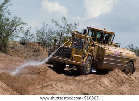 Heavy water hauler doing dust abatement on road construction project.