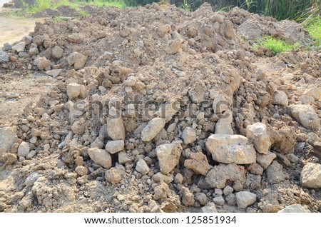 piles of land and stones mined by excavation in construction site
