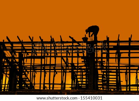 Silhouette of construction worker working on a construction site