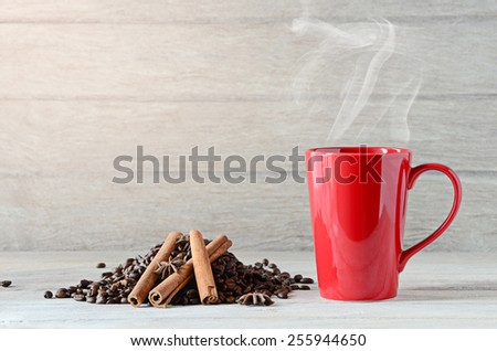 Red Coffee cup and coffee beans on wooden table