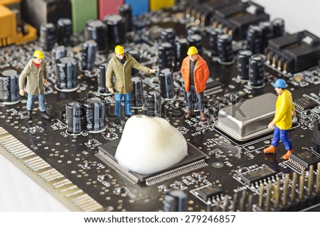 Miniature Technicians try to fix computer problem