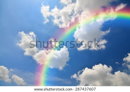 Rainbow and White clouds in blue sky background