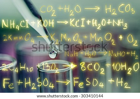 laboratory test tubes with chemical equation