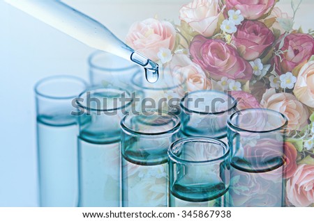 double exposure of science laboratory test tubes and flower , natural research concept