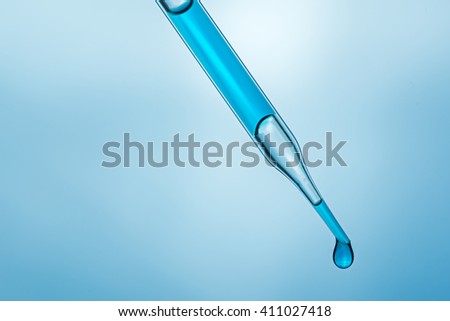 science laboratory pipette with a drop of chemical