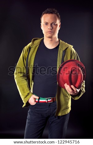 Positive handsome man wearing green jacket , red hat and belt in Italia or Hungarian flag- green, white, red