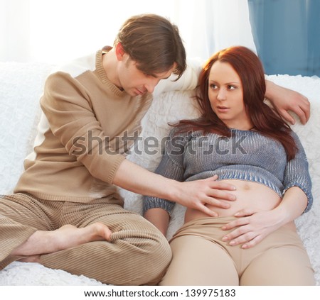 Pregnant couple on the sofa. relaxing