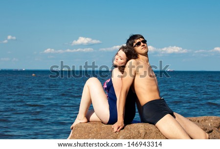 couple of lovers or family relaxing on the sea short. Plus size woman and slim man