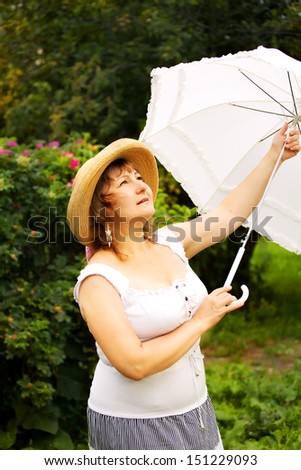 Plus size woman relaxing in the park, waiting rain