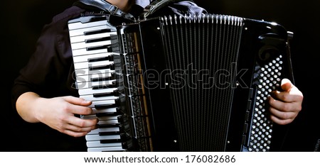 Hands of musician accordionist  and  frayed keys of  accordion