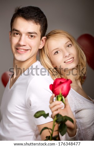 Young couple of lovers. Man presents flower