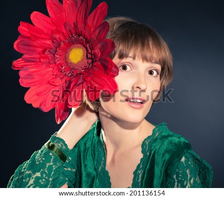 funny girl wearing vintage velvet and lace dress holding huge red flower