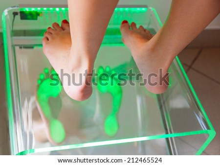 examining feet using Plantoscopy in medical office