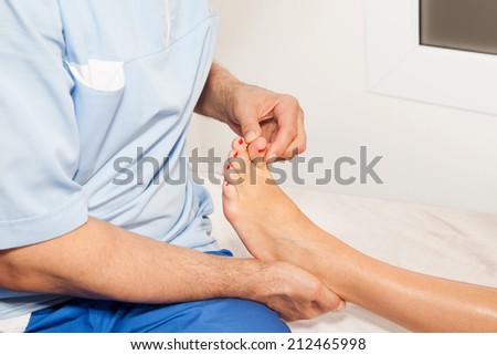 Doctor orthopedist  make examination of the foot in his office