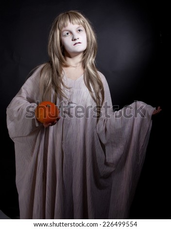 Teen girl wearing as zombie or dead princess for Halloween over dark background