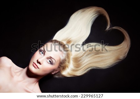 Beautiful blonde  woman with long hair. shape heart