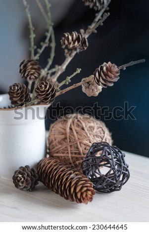 Floral composition with branches, pine cones
