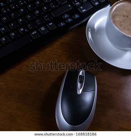 keyboard, cup coffee and mouse on desk
