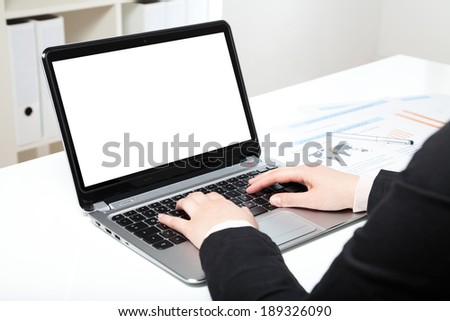 woman in office with laptop and white desk