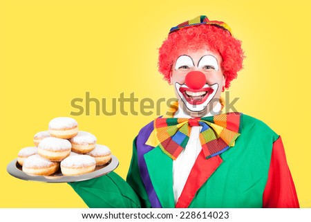 clown with berlin pancakes on yellow background