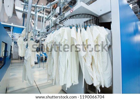 Washed clothes are being conveyed to ironing machine