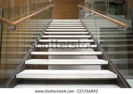 Modern white stairs with wooden handrail