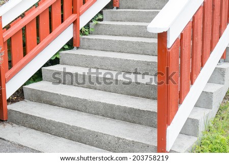 Cement stairs with wooden handrail