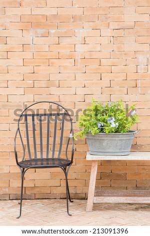 Hand made chair wrought iron with flower on classic wall