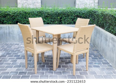 Rattan chair and table in garden