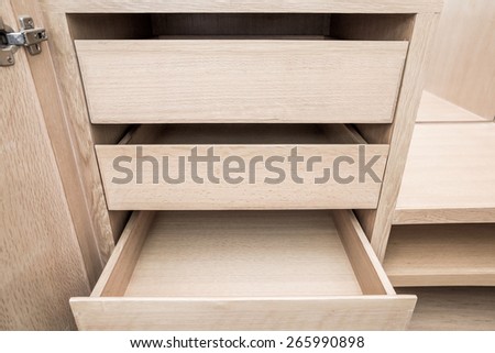 wooden cupboard opened empty drawers