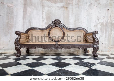 vintage style of interior decoration  sofa with black and white floor and old concrete wall