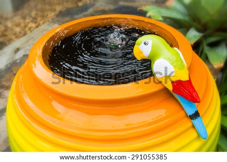 colorful Bird on Fountain decoration in the garden made by Clay pottery ceramic