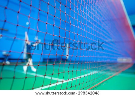 net badminton in court with players competing