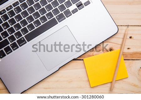 computer with sticky note paper on wooden table